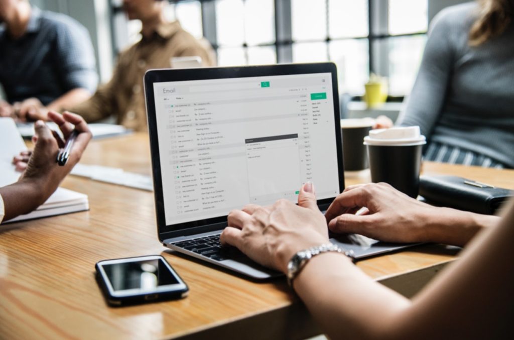 woman using email in a meeting